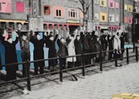 a group of people standing on a sidewalk