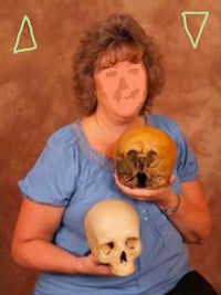 a woman holding a skull and a triangle