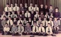 a group of children in school uniforms posing for a photo