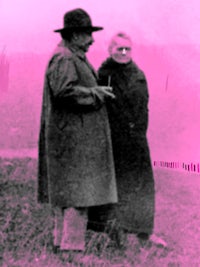 a man and woman standing in a field