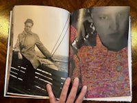 an open book with a photo of a woman on a boat