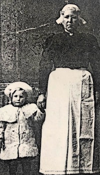 an old black and white photo of a woman and a child