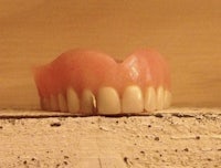 a model of a tooth sitting on top of a wall