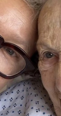 a woman in glasses is posing for a selfie with an older woman