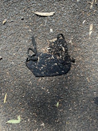 a black shoe is laying on the ground