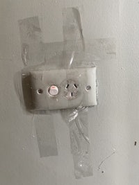 a light switch is taped to the wall