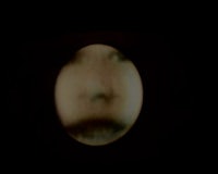 an image of a person's face in a dark room