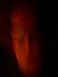 a person's face in the dark