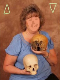 a woman is holding two skulls in front of her