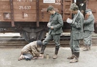 a group of soldiers standing next to a train