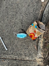 a mcdonald's bag on the sidewalk