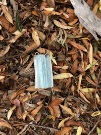 a medical mask laying on the ground