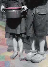 two children standing next to each other holding pots