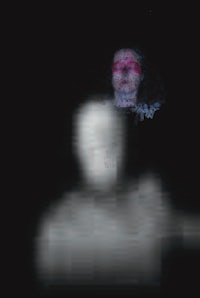 a blurry image of a man and a woman in the dark