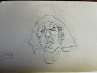 a drawing of a man with glasses in a notebook