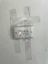 a white wall with tape on it