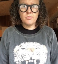 a woman wearing glasses and a tiger sweatshirt