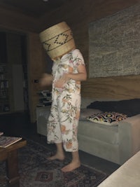 a child wearing a hat in a living room