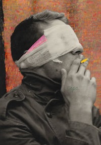 a man wearing a blindfold smoking a cigarette