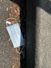 a medical mask lying on the sidewalk