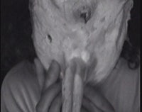 a black and white photo of a person with a mask on