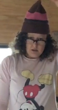 a woman wearing a mickey mouse t - shirt