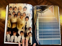 an open book with a photo of a group of people