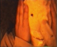 a person is covering their face with a teddy bear