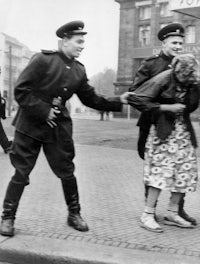 a woman is being escorted by a police officer